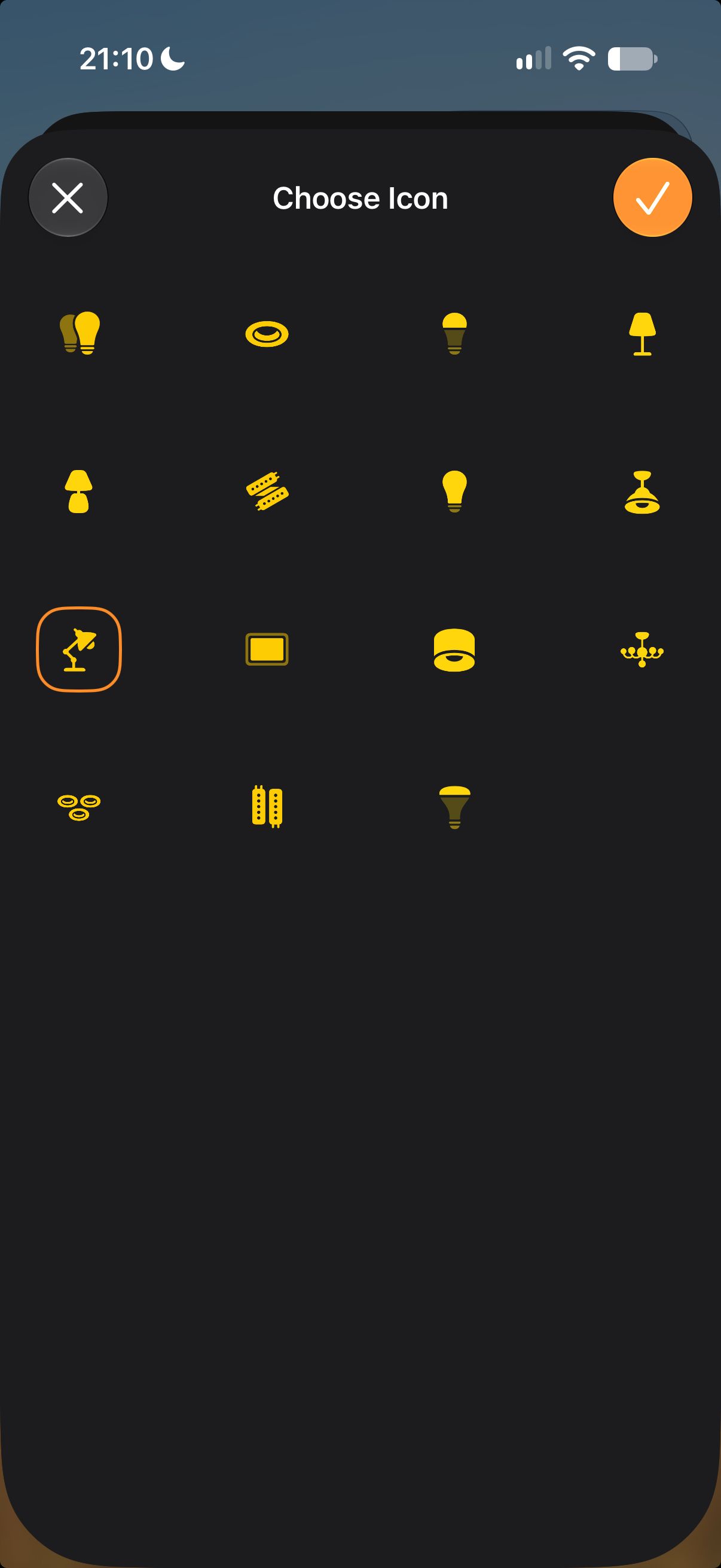 The Apple Home Choose Icon screen in dark mode, with 15 yellow light icons and the desk lamp picked